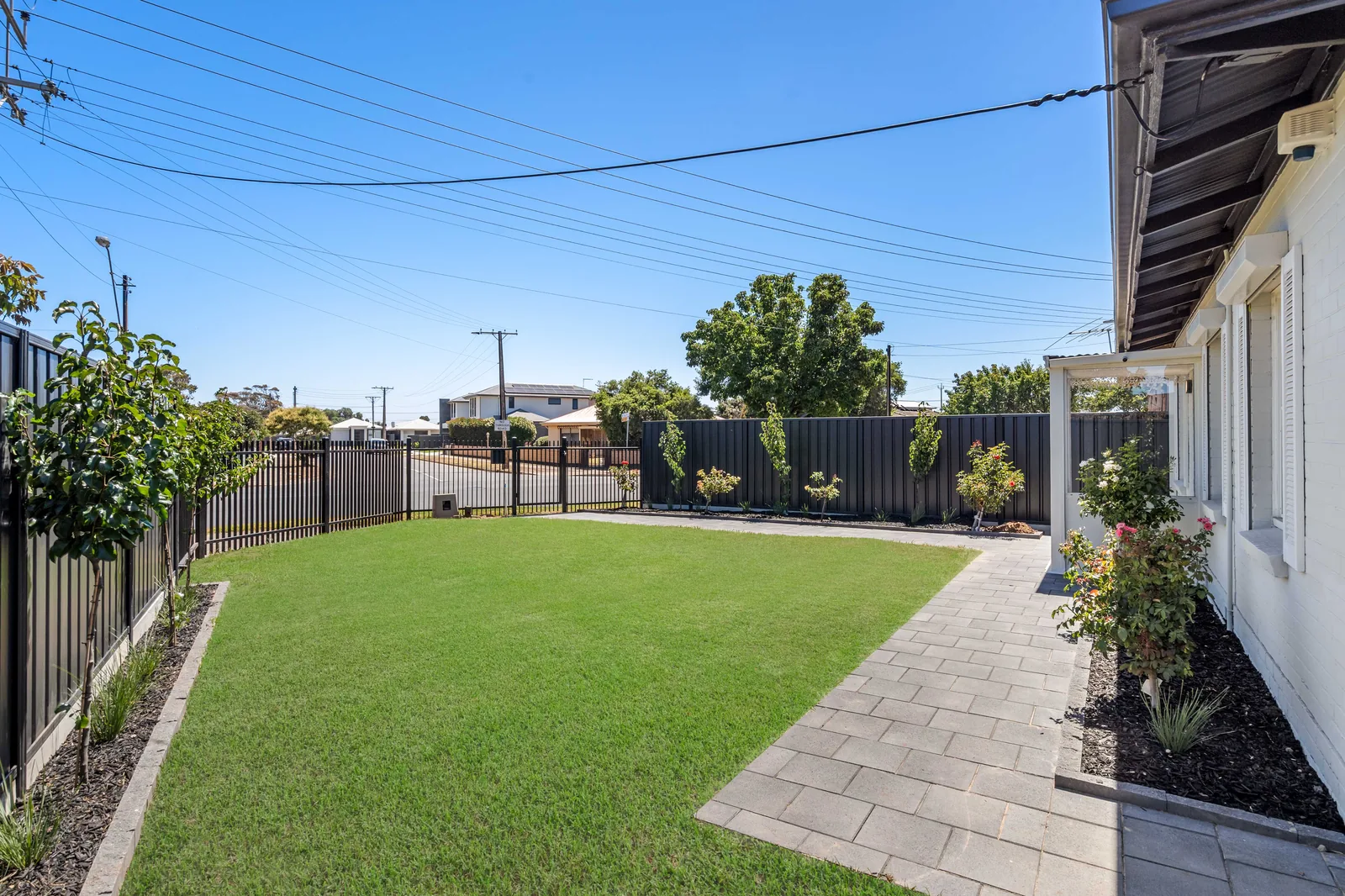 Backyard with established lawn and gardens